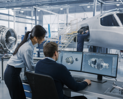 two aerospace engineers discussing cad designs on monitors for aerospace engineering talent recruitment.